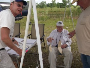 Bob Warmann in the foreground resting after winning Cat. Glider with a 3 1/2 minute flight.